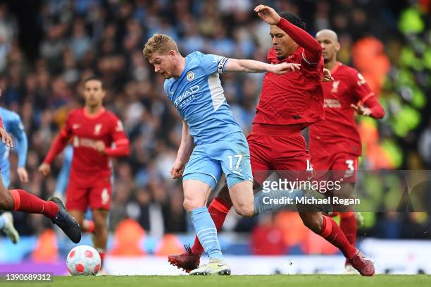 Kevin De Bruyne of Manchester City is challenged by Virgil van Dijk of Liverpool during the Premier League match between Manchester City and...