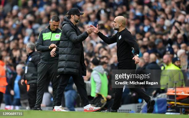 Jurgen Klopp, Manager of Liverpool and Pep Guardiola, Manager of Manchester City interact after the Premier League match between Manchester City and...