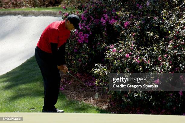 Tiger Woods plays his shot left-handed on the 13th hole during the final round of the Masters at Augusta National Golf Club on April 10, 2022 in...
