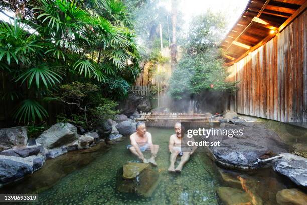 two senior males taking a outdoor japanese onsen hot spring - hot spring 個照片及圖片檔