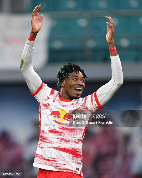 Mohamed Simakan of RB Leipzig celebrates after their side's third goal scored by Dominik Szoboszlai of RB Leipzig during the Bundesliga match between...