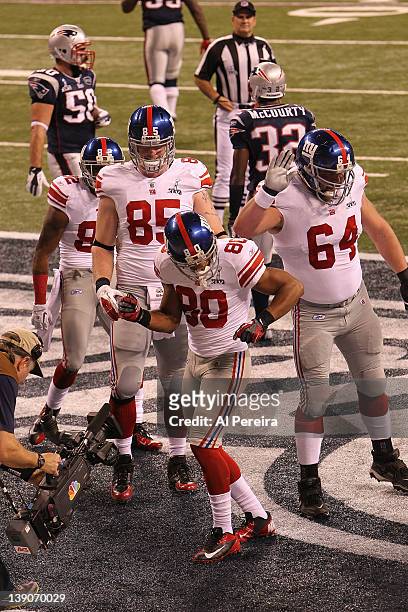 Wide Receiver Victor Cruz of the New York Giants has a Touchdown and celebrates against the New England Patriots in Super Bowl XLVI at Lucas Oil...