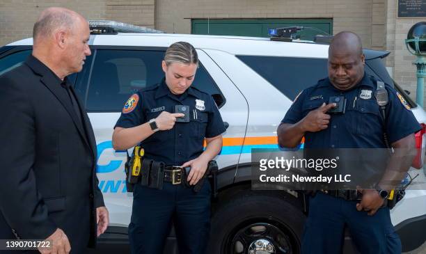 Nassau County Police officers show their new body cameras outside of Nassau County Police Headquarters in Mineola, New York on Aug. 27, 2021.