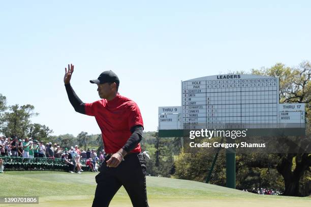 Tiger Woods waves to the crowd on the 18th green after finishing his round during the final round of the Masters at Augusta National Golf Club on...