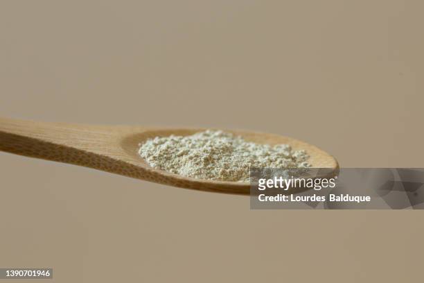 flour, clay, powder, ingredient in wooden spoon, close up view - oat ear stockfoto's en -beelden