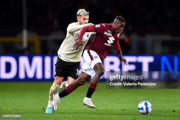 Wilfried Singo of Torino FC battles for possession with Theo Hernandez of AC Milan during the Serie A match between Torino FC and AC Milan at Stadio...