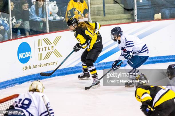 Alexis Ryan of the Middlebury Panthers defends Emily Olson of the Gustavus Adolphus Gusties during the NCAA Division III Women's Ice Hockey...