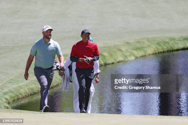 Jon Rahm of Spain and Tiger Woods walk to the 16th green during the final round of the Masters at Augusta National Golf Club on April 10, 2022 in...