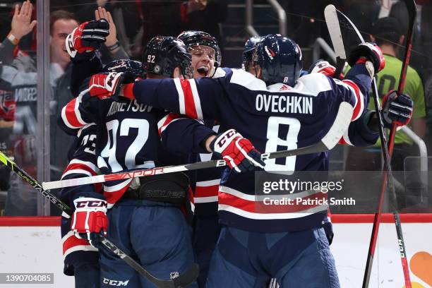 John Carlson of the Washington Capitals celebrates his goal with teammates against the Boston Bruins during the second period at Capital One Arena on...