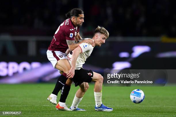 Alexis Saelemaekers of AC Milan battles for possession with Ricardo Rodriguez of Torino FC during the Serie A match between Torino FC and AC Milan at...