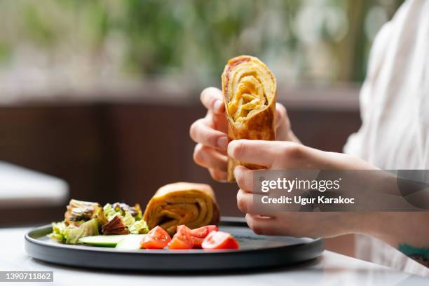 woman eating burrito - wrap sandwich stock pictures, royalty-free photos & images