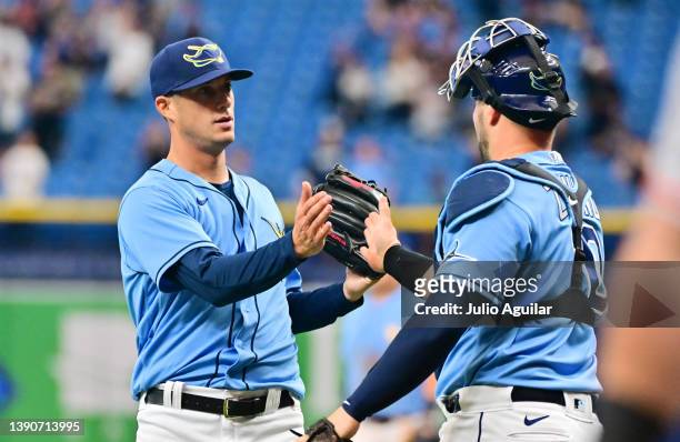 Matt Wisler (left of the Tampa Bay Rays celebrates with Mike Zunino after defeating the Baltimore Orioles 8-0 at Tropicana Field on April 10, 2022 in...