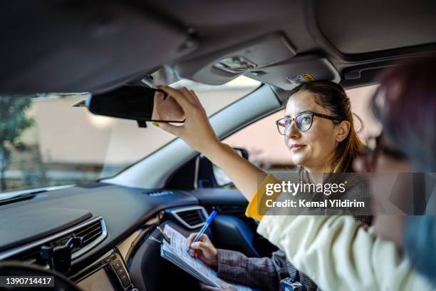 teenager girl having driving lesson with female instructor - driving course stock pictures, royalty-free photos & images