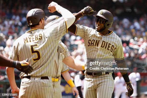 Jurickson Profar of the San Diego Padres celebrates with Wil Myers after hitting a grand slam against the Arizona Diamondbacks during the second...