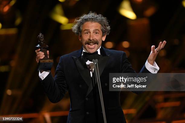 Elliot Levey on stage accepting his award for Best Actor in a Supporting Role in a Musical for "Cabaret"during The Olivier Awards 2022 with...