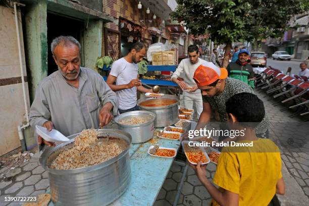 Ali Helmy cooks and distributes food visitors during Ramadan in the land of Jacob in the Sayeda Zainab district on April 10, 2022 in Cairo, Egypt....