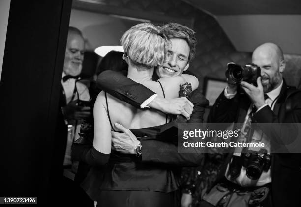 Jessie Buckley, winner of the Best Actress in a Musical award for "Cabaret at the Kit Kat Club", hugs Eddie Redmayne, winner of the Best Actor in a...