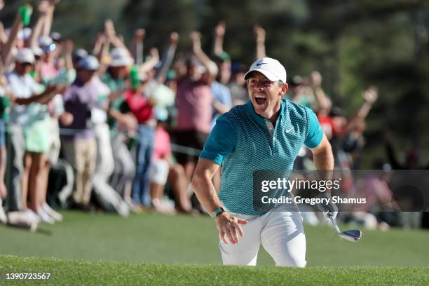 Rory McIlroy of Northern Ireland reacts after chipping in for birdie from the bunker on the 18th green during the final round of the Masters at...