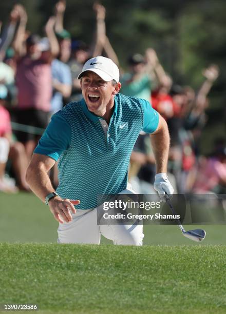 Rory McIlroy of Northern Ireland reacts after chipping in for birdie from the bunker on the 18th green during the final round of the Masters at...