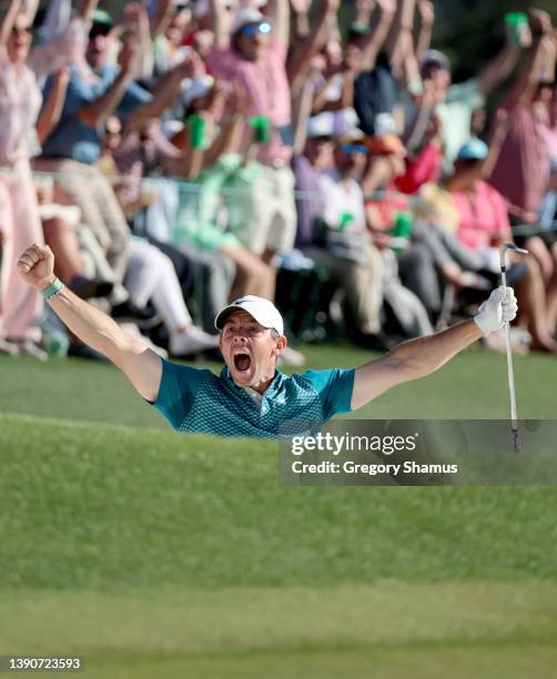 Rory McIlroy of Northern Ireland reacts after chipping in for birdie from the bunker on the 18th green during the final round of the Masters at...