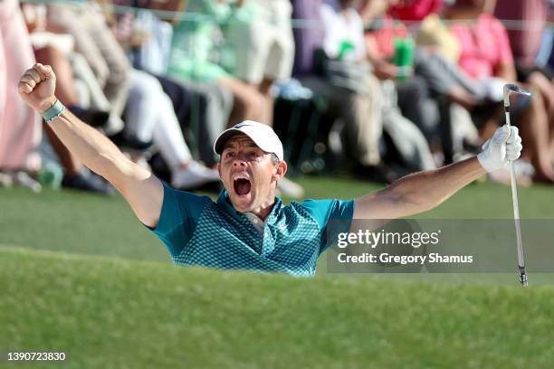 Rory McIlroy of Northern Ireland reacts after chipping in for birdie from the bunker on the 18th green during the final round of the Masters at...