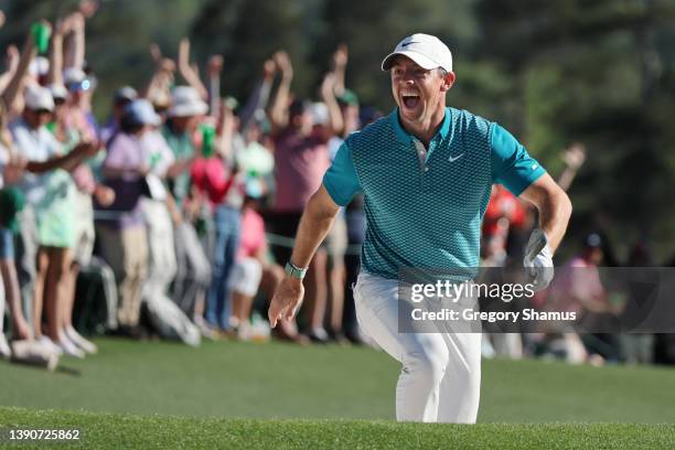 Rory McIlroy of Northern Ireland reacts after chipping in for birdie from the bunker on the 18th green during the final round of the Masters at...