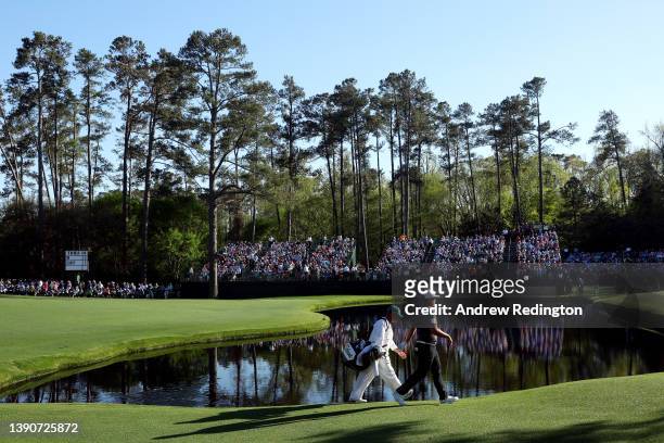 Sungjae Im of South Korea and caddie William Spencer walk across the 15th hole during the final round of the Masters at Augusta National Golf Club on...