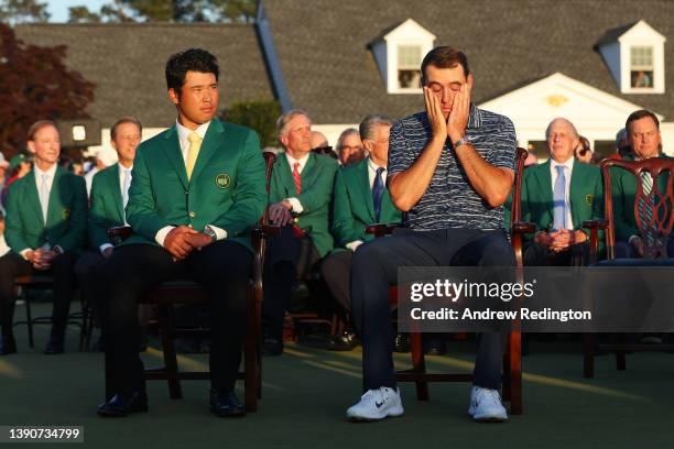 Hideki Matsuyama of Japan , winner of the 2021 Masters, and Scottie Scheffler look on during the Green Jacket Ceremony after Scheffler won the...