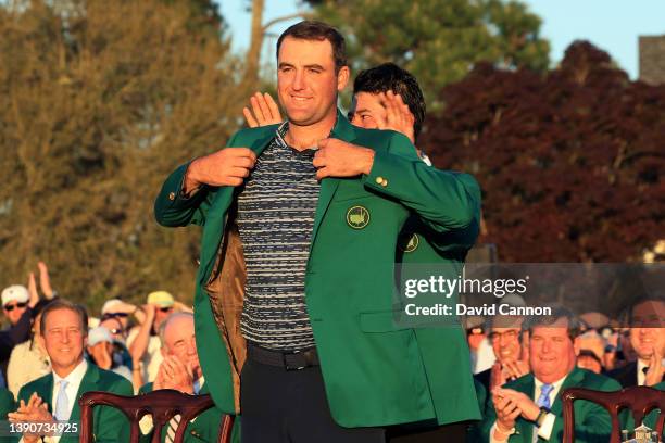 Scottie Scheffler is awarded the Green Jacket by 2021 Masters champion Hideki Matsuyama of Japan during the Green Jacket Ceremony after he won the...