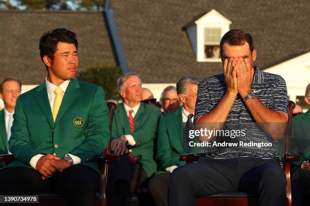 Hideki Matsuyama of Japan , winner of the 2021 Masters, and Scottie Scheffler look on during the Green Jacket Ceremony after Scheffler won the...