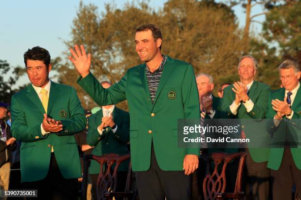 Scottie Scheffler waves to the crowd after being awarded the Green Jacket by 2021 Masters champion Hideki Matsuyama of Japan during the Green Jacket...