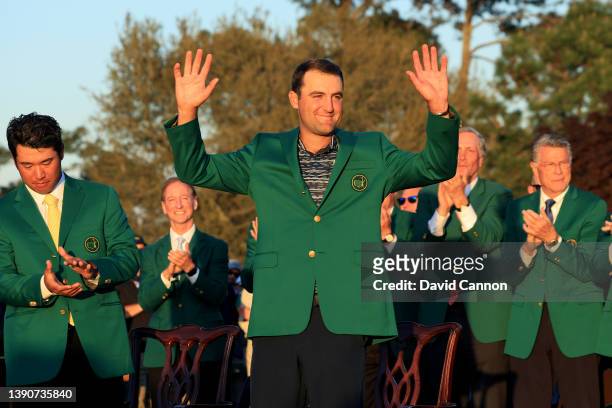 Scottie Scheffler celebrates after being awarded the Green Jacket by 2021 Masters champion Hideki Matsuyama of Japan during the Green Jacket Ceremony...