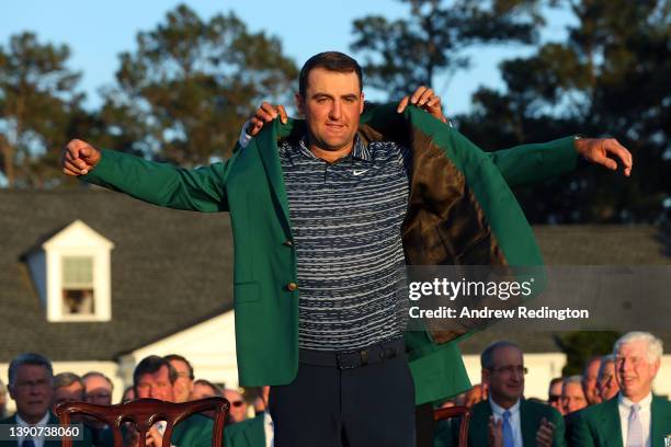 Scottie Scheffler is awarded the Green Jacket by 2021 Masters champion Hideki Matsuyama of Japan during the Green Jacket Ceremony after he won the...