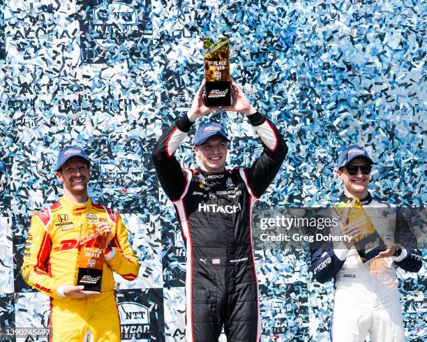 IndyCar Series drivers Romain Grosjean , Josef Newgarden and Alex Palou celebrate on the finish podium at the 2022 Acura Grand Prix Of Long Beach on...