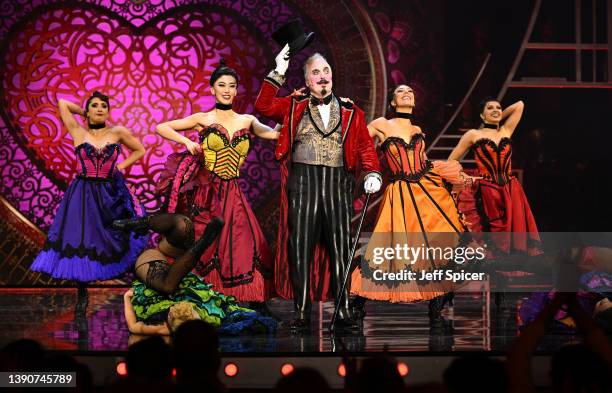 Clive Carter performs on stage with the cast of Moulin Rouge on stage during The Olivier Awards 2022 with MasterCard at the Royal Albert Hall on...