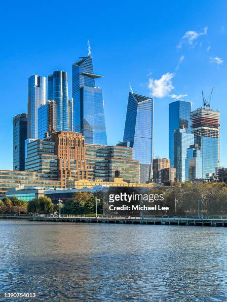 skyline view of hudson yards and manhattan west from pier 62 in new york - hudson yards stock pictures, royalty-free photos & images