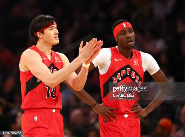 Yuta Watanabe and Chris Boucher of the Toronto Raptors walk off the court during a time out late in the fourth quarter against the New York Knicks at...