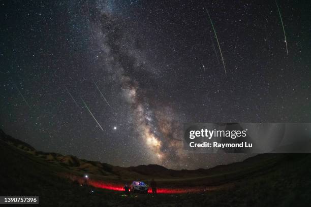 a group of people taking photos of meteo shower and milky way - 敦煌 stock pictures, royalty-free photos & images