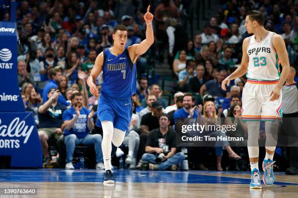 Dwight Powell of the Dallas Mavericks of the Dallas Mavericks reacts after making a basket as Zach Collins of the San Antonio Spurs looks on in the...