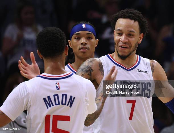 Amir Coffey of the LA Clippers celebrates with Xavier Moon and Brandon Boston Jr. #4 during a 138-88 Clippers win over the Oklahoma City Thunder at...