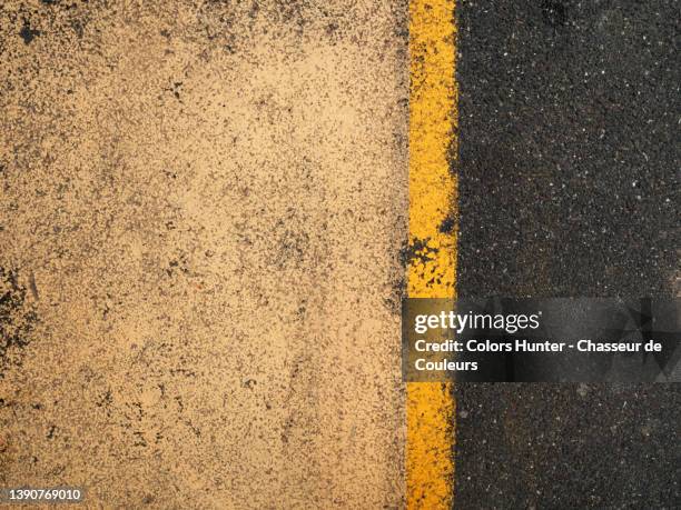 close-up of a weathered and textured road markings in paris - brown imagens e fotografias de stock