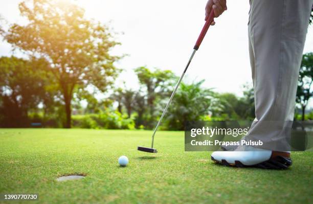 golfer hitting golf shot with club on course - golf tee ストックフォトと画像
