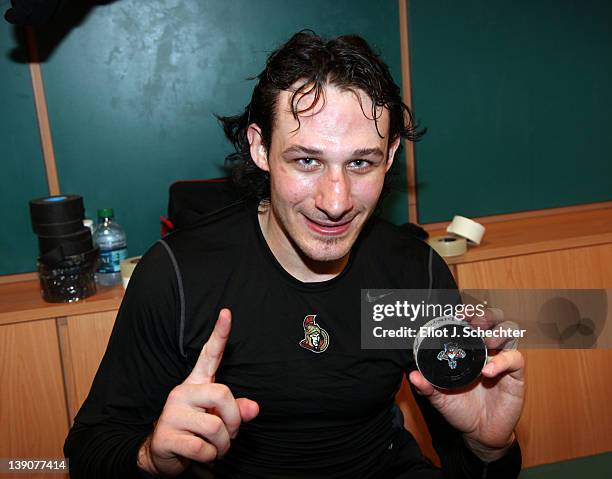 Jim O'Brien of the Ottawa Senators holds up a puck in the locker room after scoring his first NHL goal against the Florida Panthers at the...