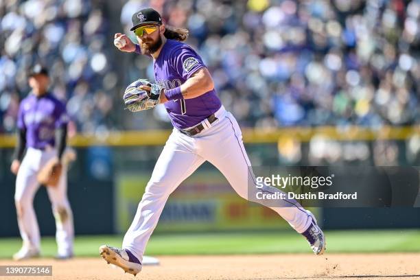 Brendan Rodgers of the Colorado Rockies throws to first base after fielding a ground ball against the Los Angeles Dodgers in the seventh inning...