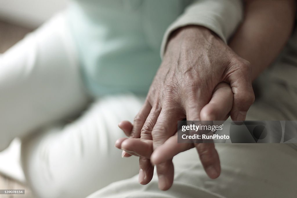 Mature couple's hands, close-up