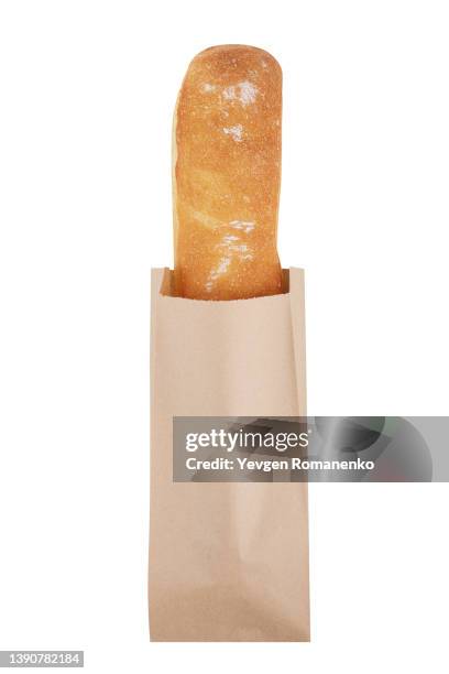 baguette in a paper bag isolated on white background - brot einkaufen stock-fotos und bilder