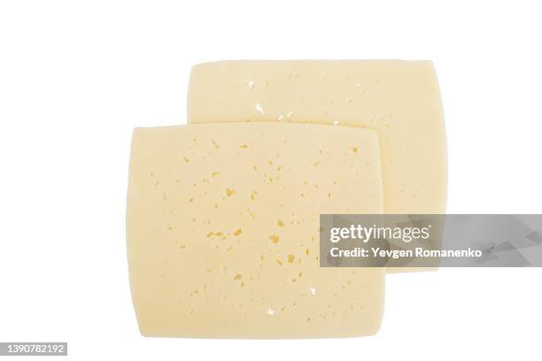 slice of cheese isolated on white background - gouda stockfoto's en -beelden