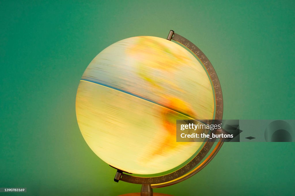 Globe in motion against green background, map of North and South America
