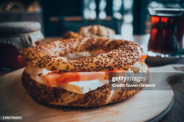 turkish bagel with cheese, tomatoes, tea, traditional turkish bagel bagel, breakfast, on a wooden background, traditional turkish breakfast with turkish bagel with cheese and tomatoes (turkish name; bagel or cereal) - istanbul food stock pictures, royalty-free photos & images