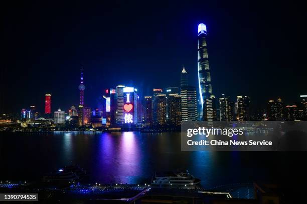 Landmark buildings at the Bund light up to support Shanghai's anti-epidemic efforts on April 10, 2022 in Shanghai, China.